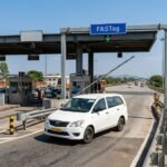 Highway toll plaza with a taxi passing through
