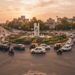 Busy Chandigarh road roundabout with evening traffic and a sedan taxi in the flow
